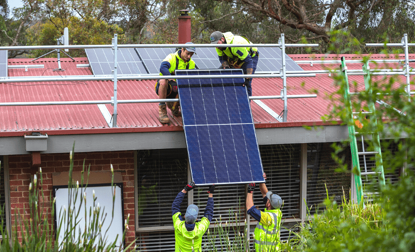 Solar industry guidance Solar installers installing a solar panel to the roof